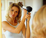 Woman Drying Hair in Front of the Mirror