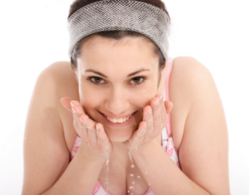 Woman Rinsing Her Skin with Water