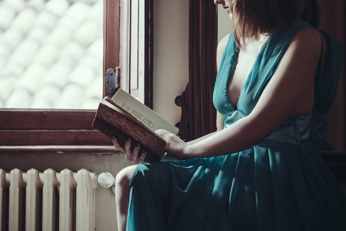 woman-breast-read-book-home-dress