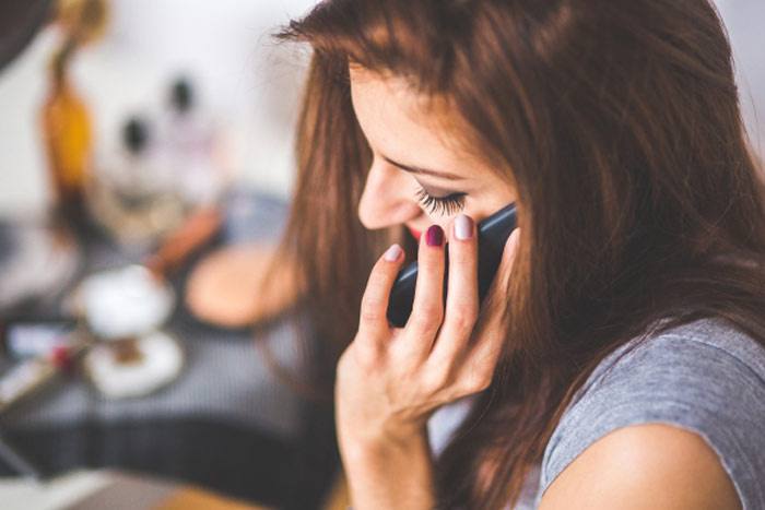 woman-talking-phone-home-manicure-speaking