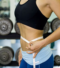 Woman Measuring Waist in a Gym