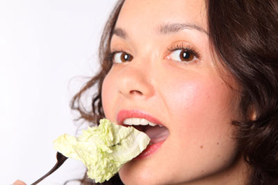 Woman eating salad