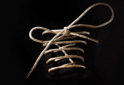 Gold shoelaces by Colin Hart