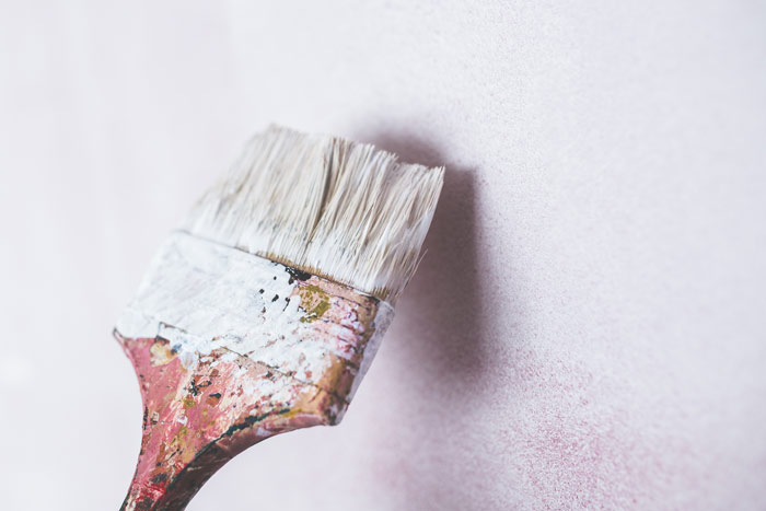 Brush-painting-the-white-wall-renovation