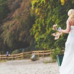 Bride-walking-alone-with-flowers-and-shoes