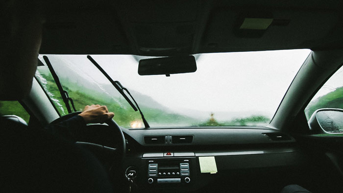 car-traveling-raining-man-driving