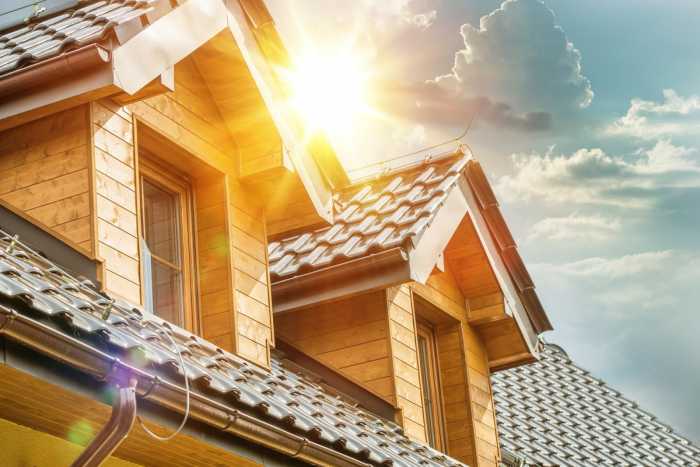 House Roof and Attic Windows Closeup. Sunny Day. Housing and Construction Concept Photo.